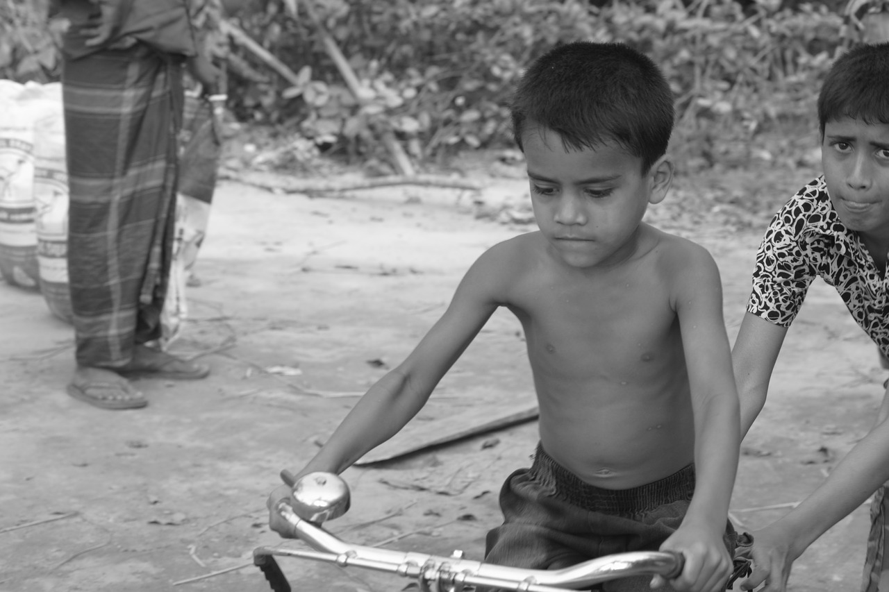 a boy try to learn cycle on the road capture this photo by other side free photo