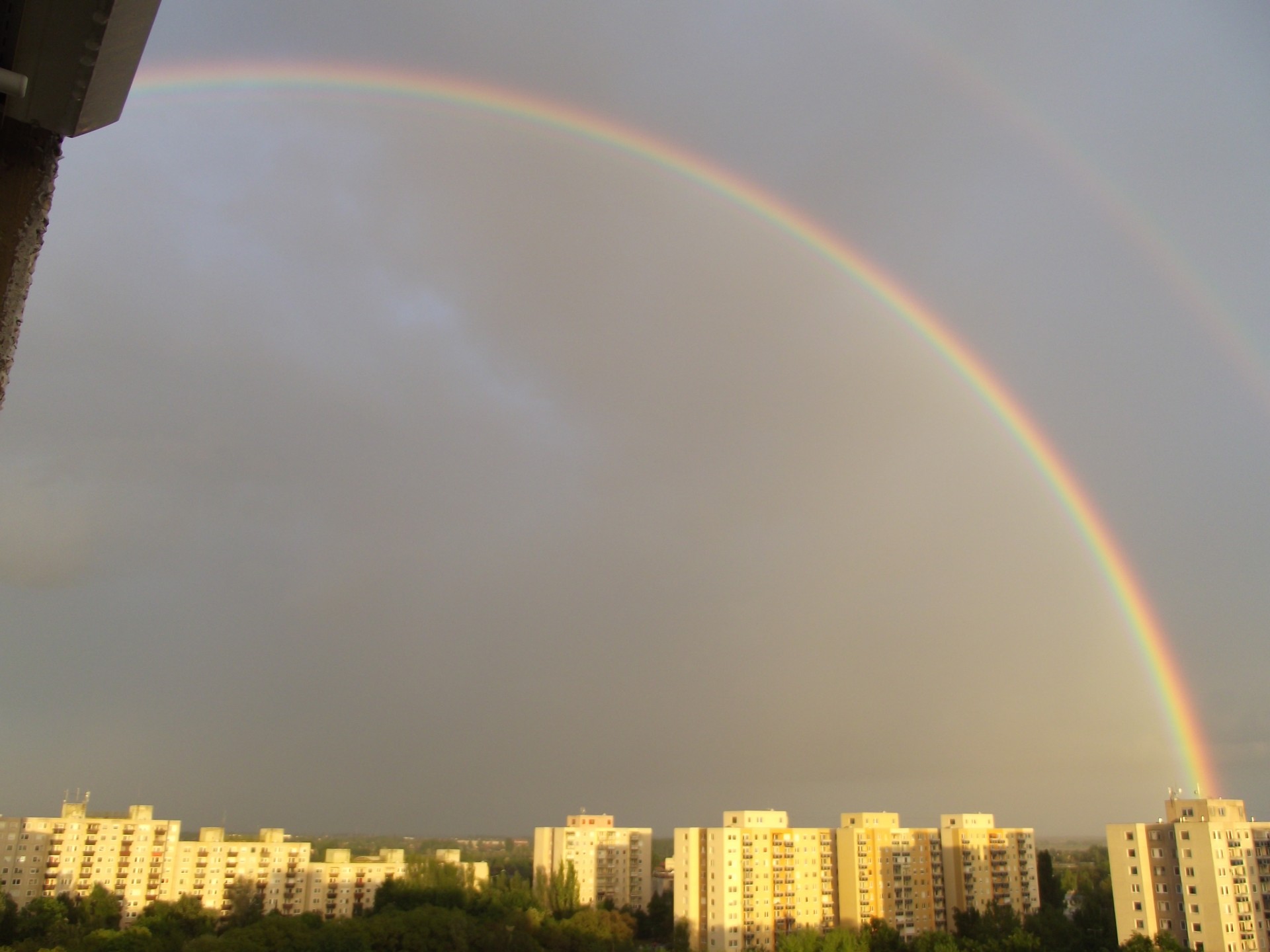 rainbow city a rainbow above the city free photo