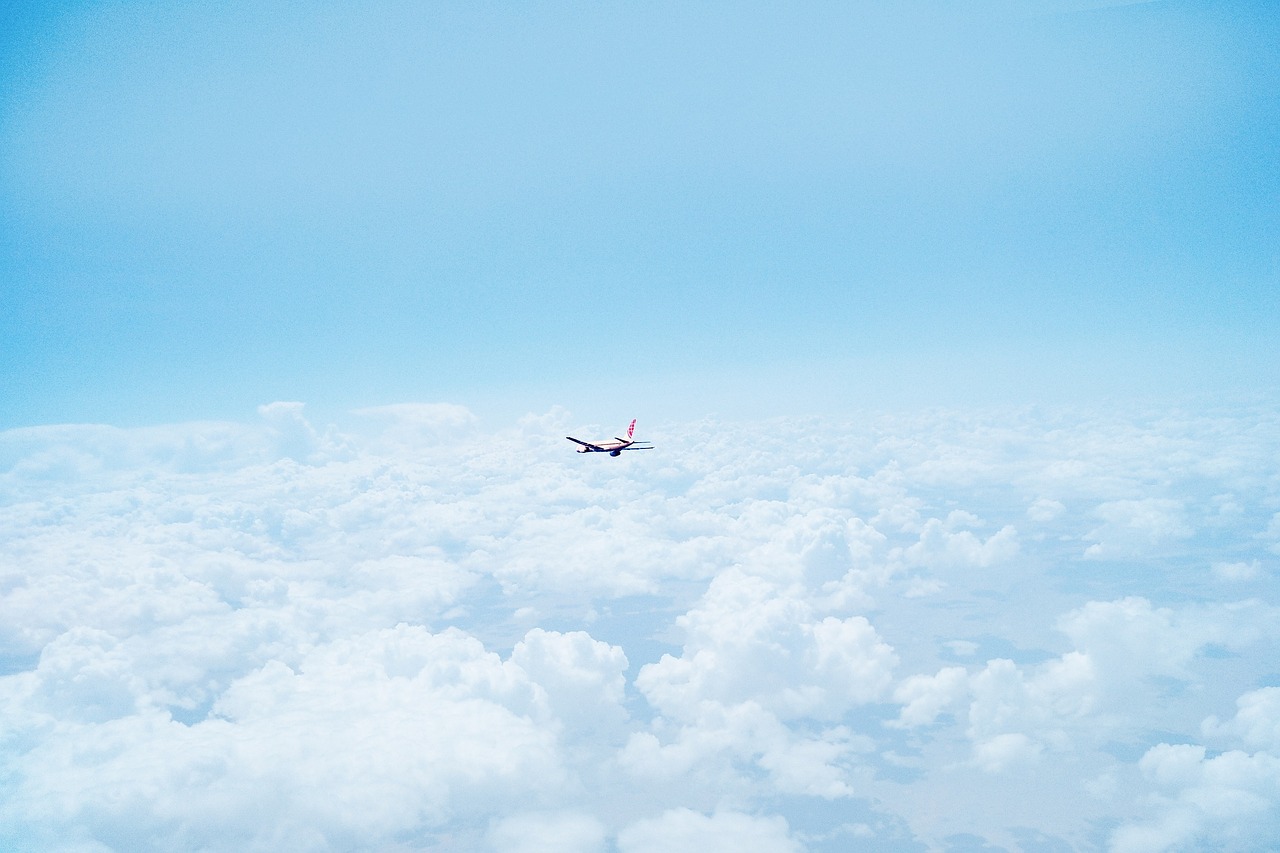 airplane above the clouds sky free photo