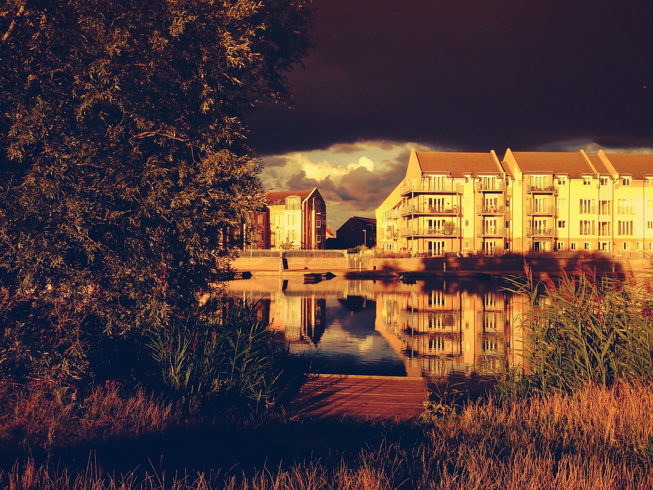 apartment building lake reflection free photo