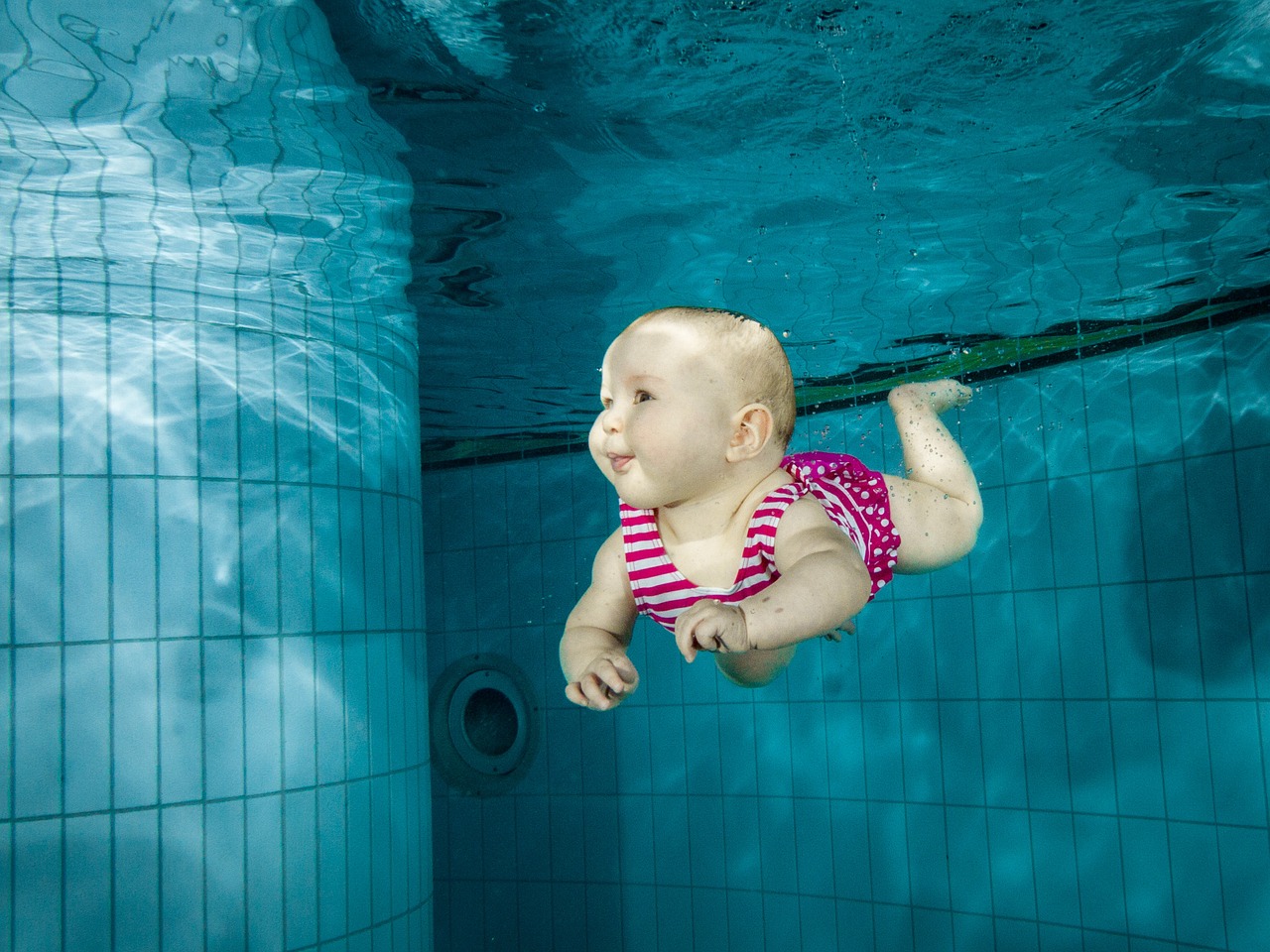 baby swimming underwater free photo