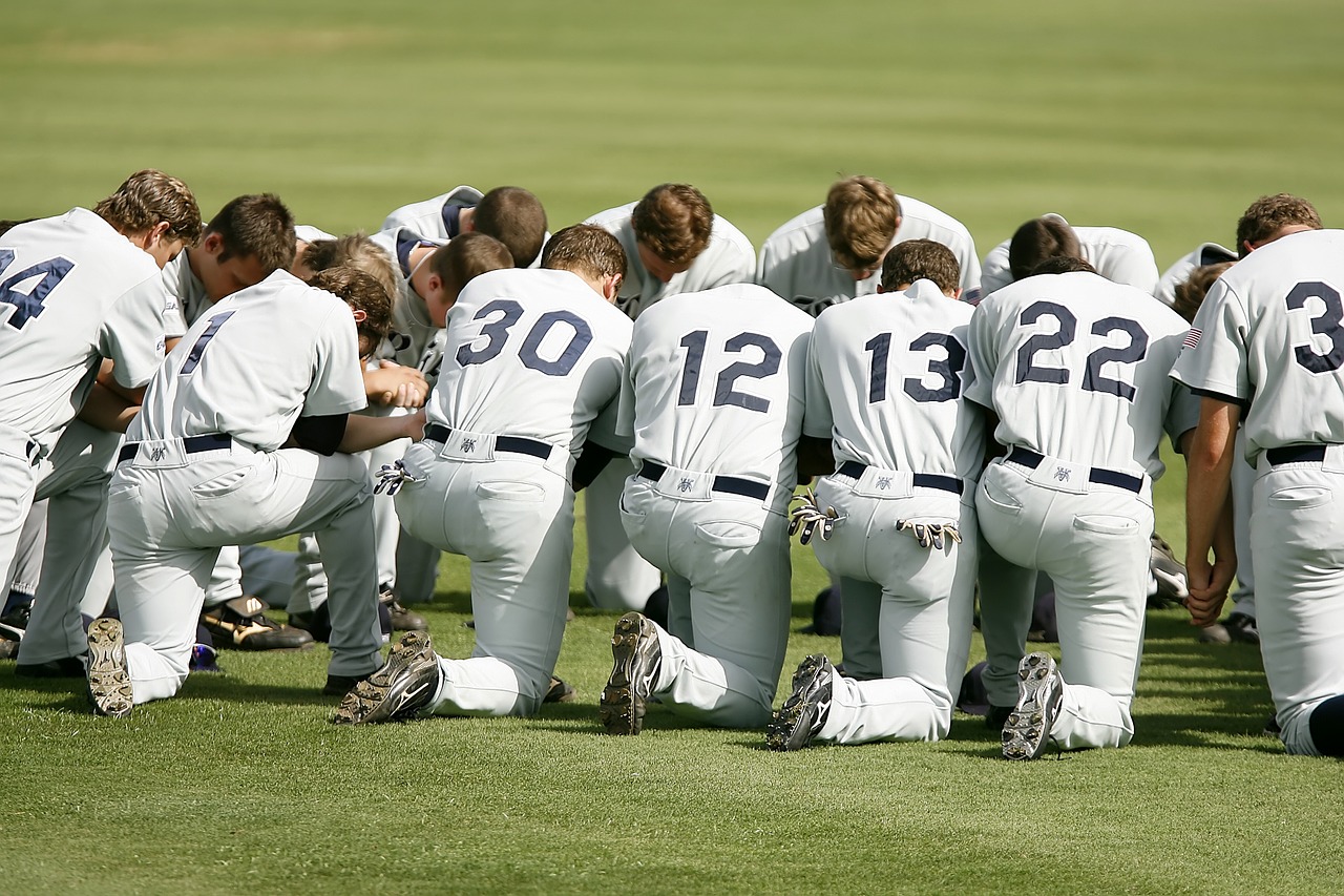 baseball team prayer kneeling free photo