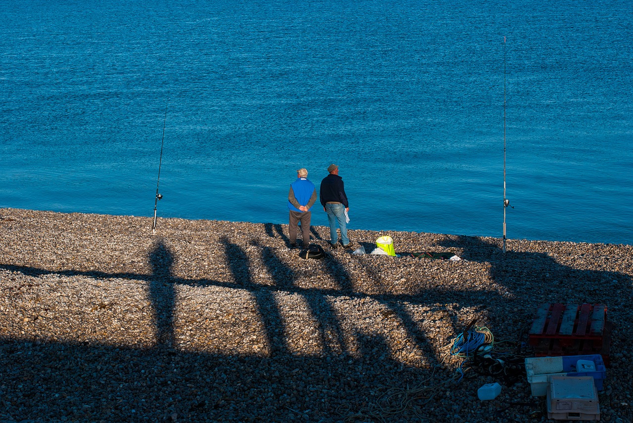 beach  sea  fisherman free photo