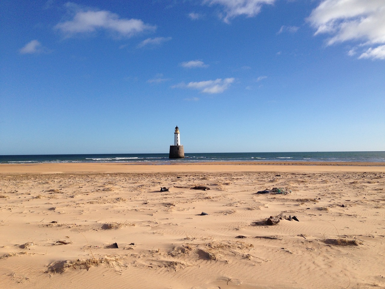 beach lighthouse sea free photo