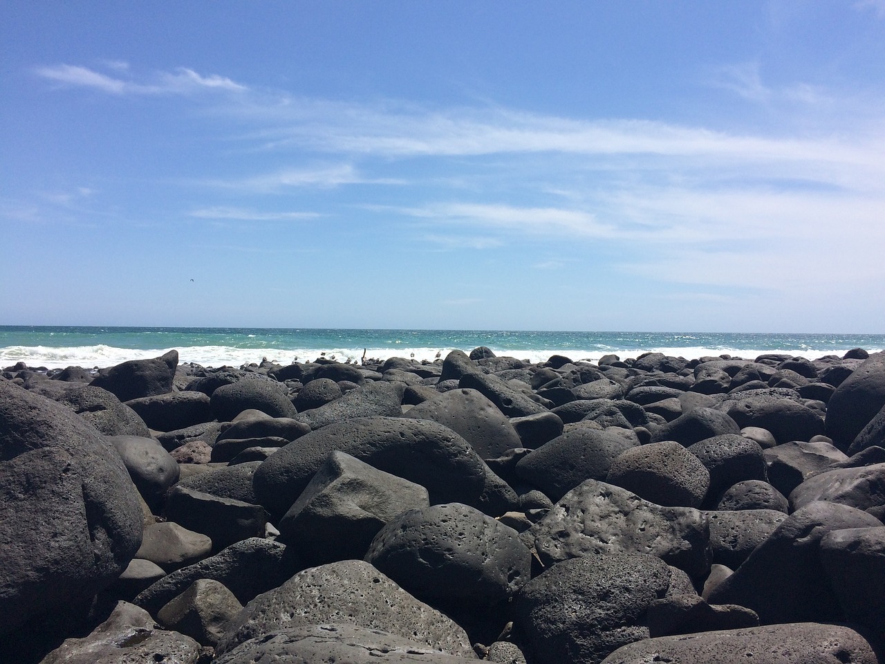 black rocky beach beach dark pebbles free photo