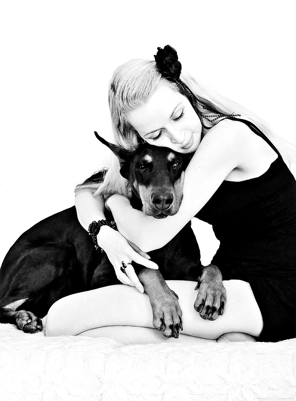 black white doberman blonde girl free photo