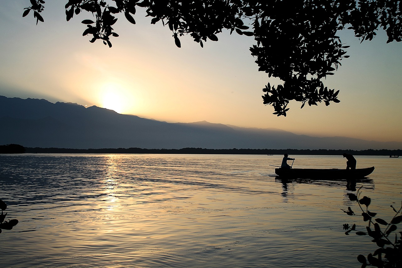 body of water sunset dawn free photo