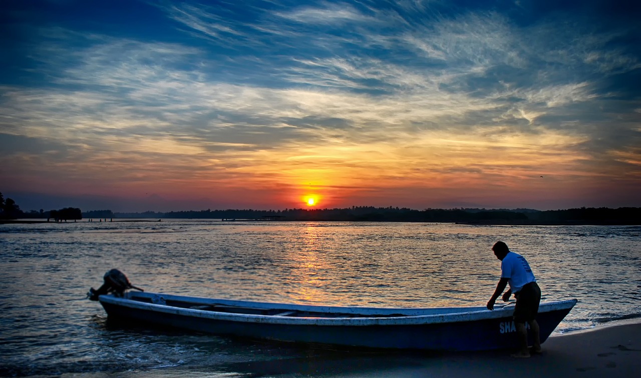 body of water sunset canoe free photo