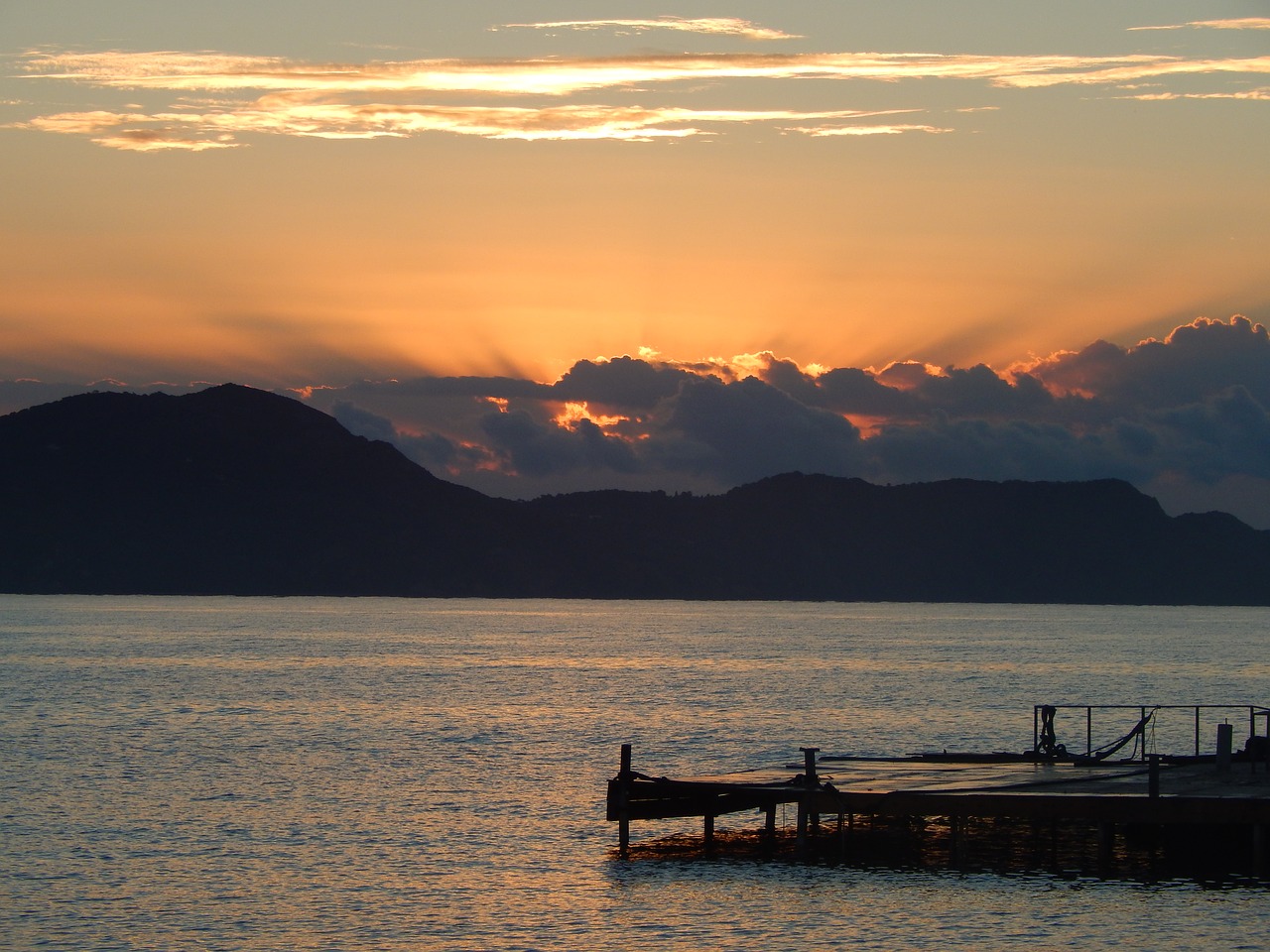 body of water sunset dawn free photo