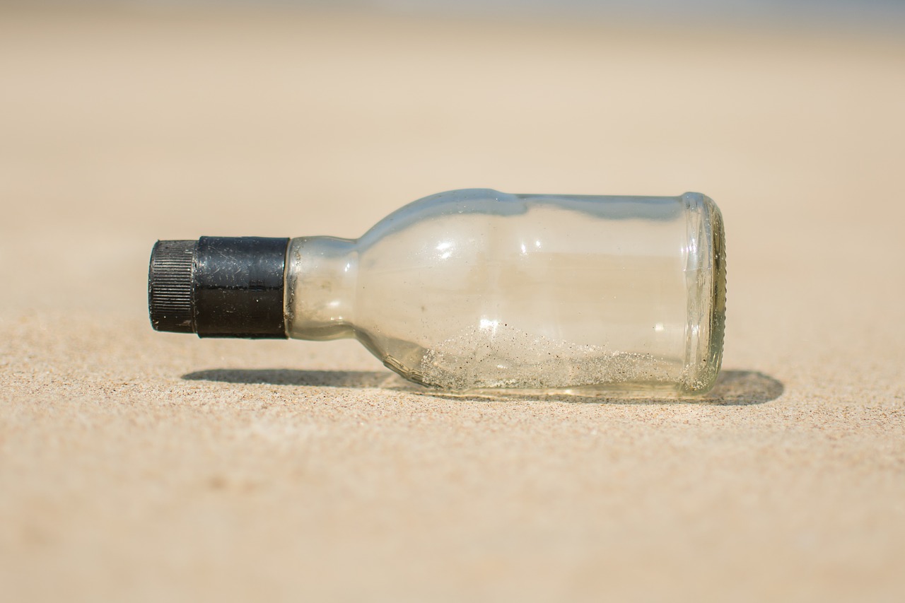 bottle  sand  beach free photo