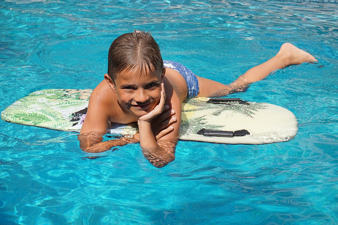 boy surfboard water free photo