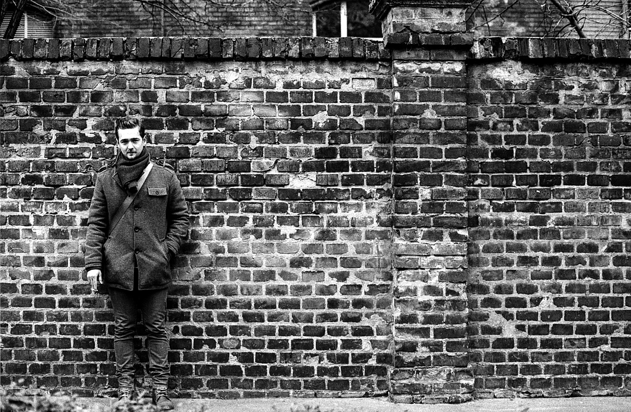 brick wall young man smoking free photo