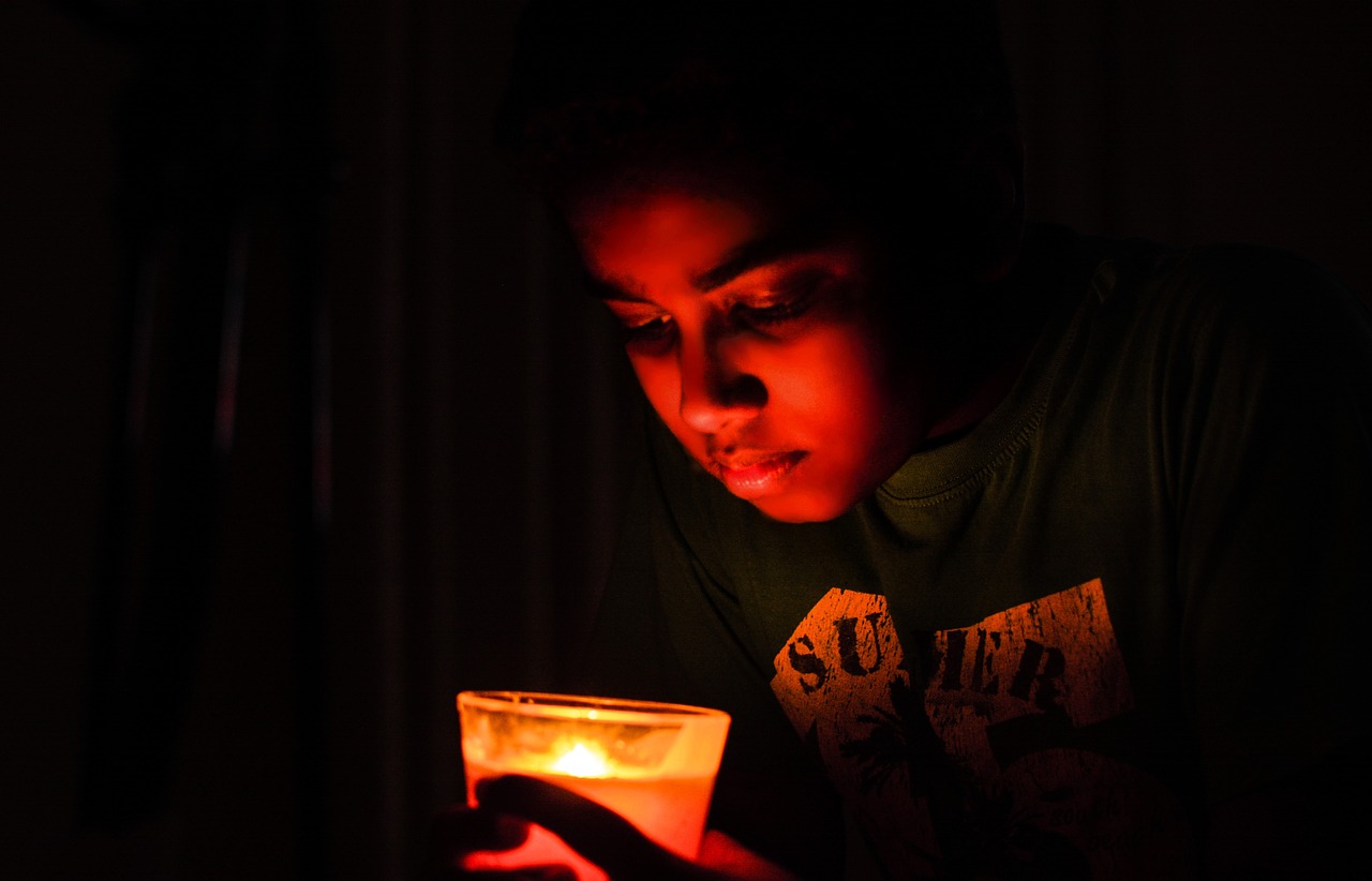 candle light little boy dark free photo