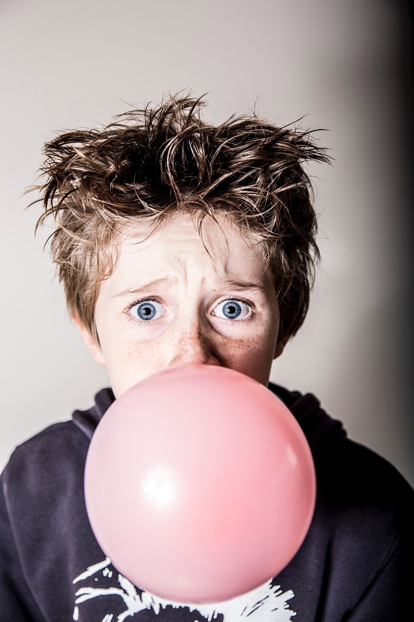 child chewing gum surprised free photo