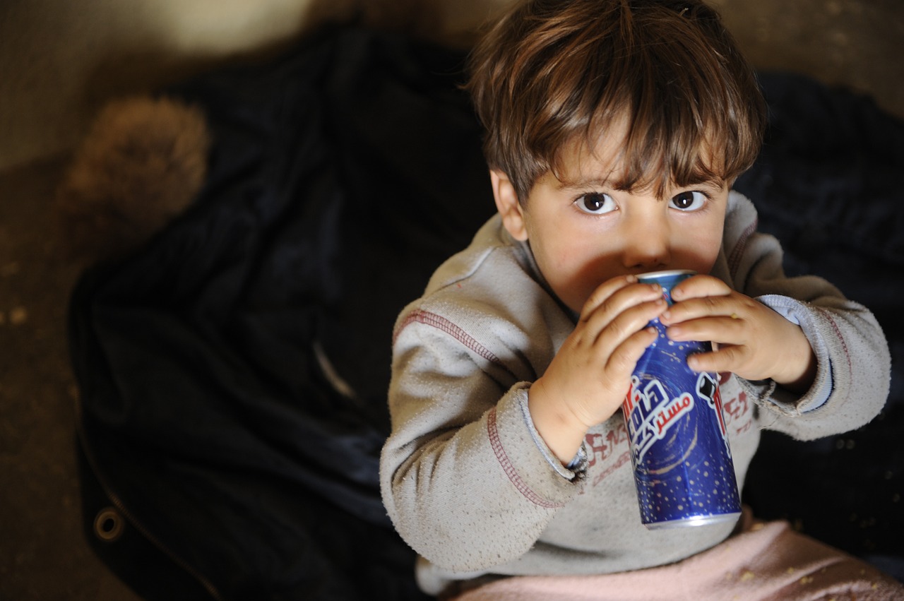 child drinking soft drink free photo