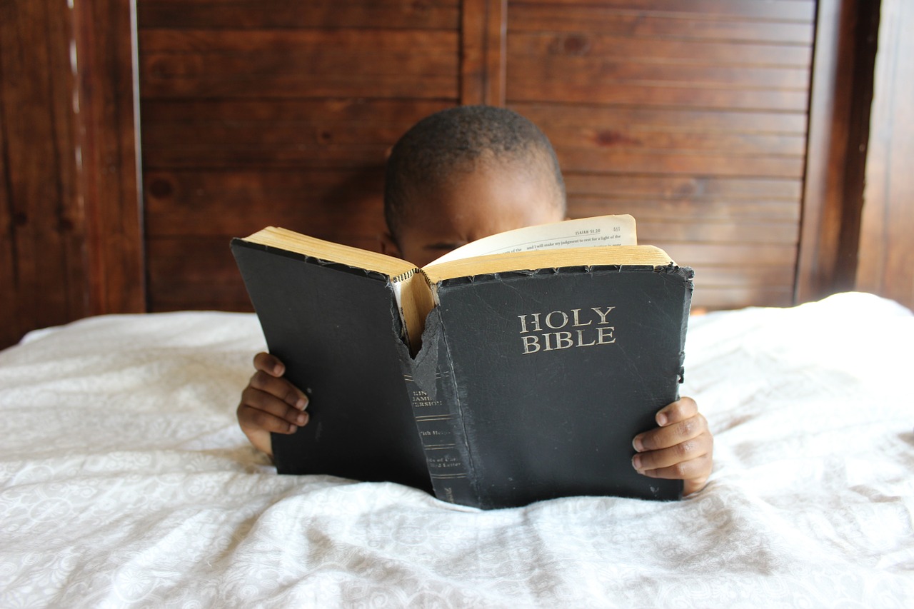child reading bible free photo