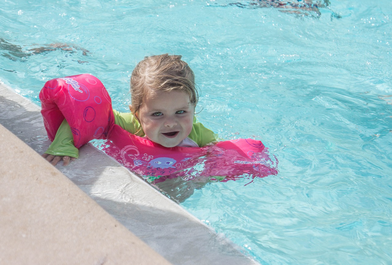 child swimming arm floats free photo
