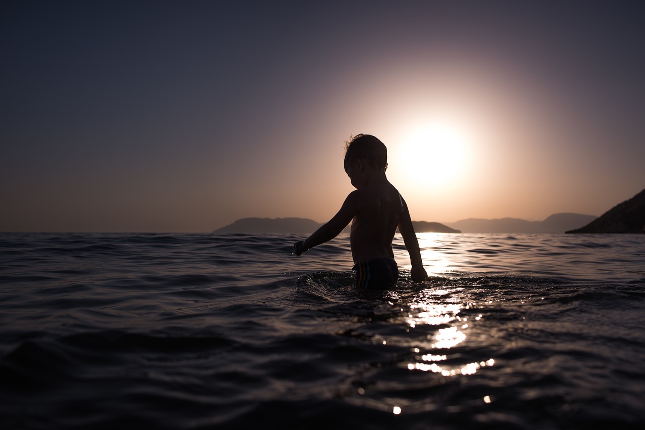 child bathing ocean free photo