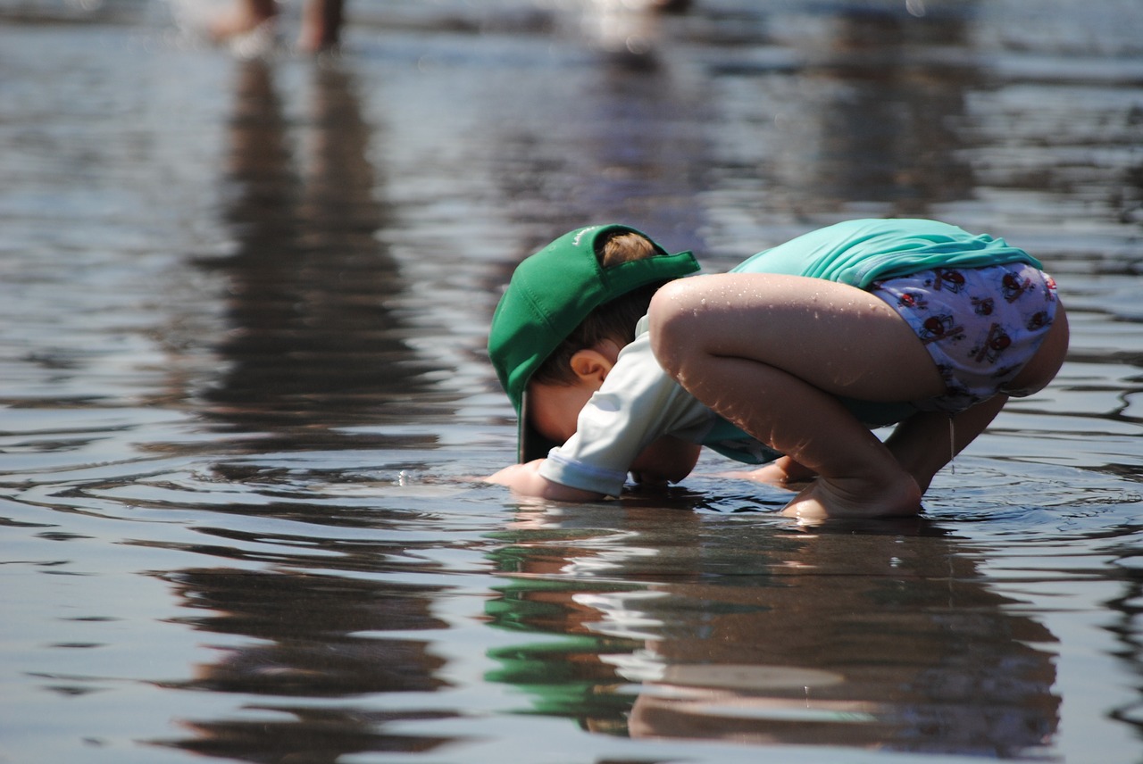 child playing in water toddler in summer child free photo