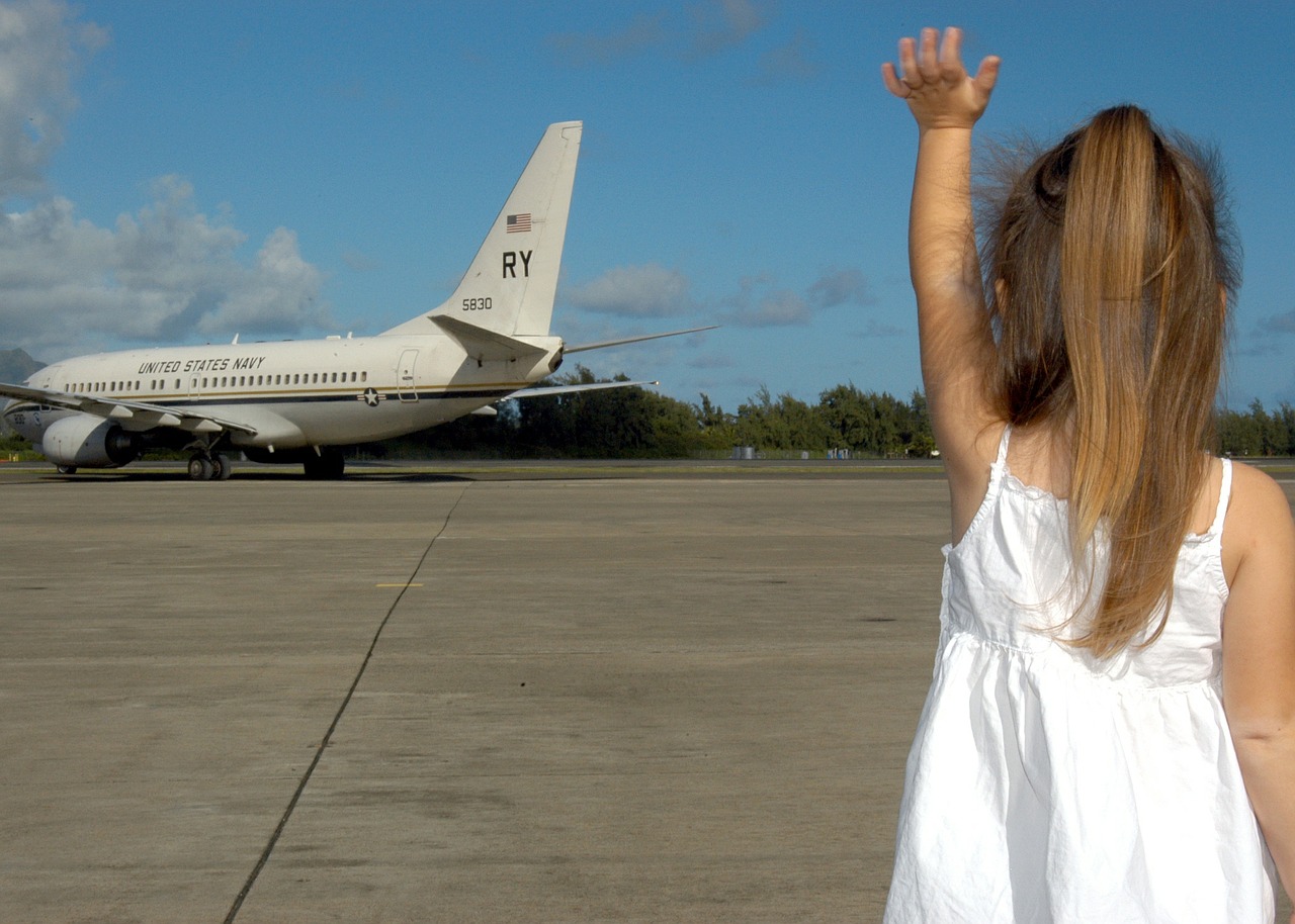 child waving goodbye departure plane free photo