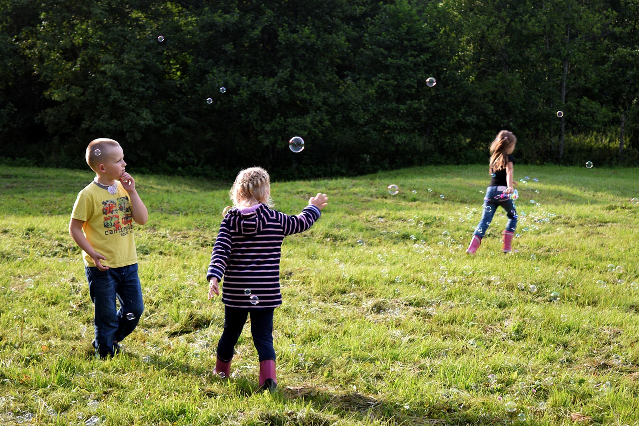 children playing soap bubbles free photo