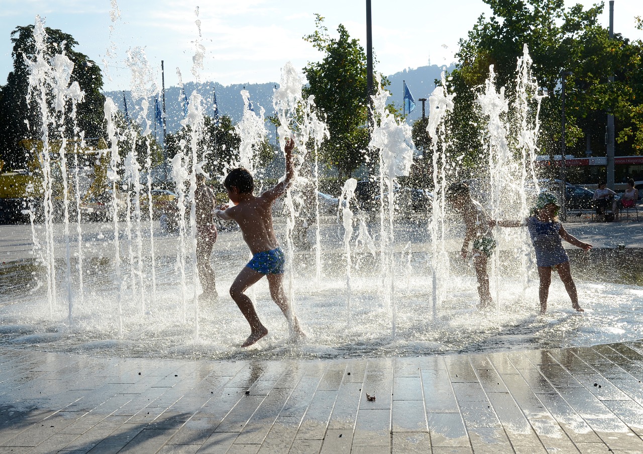 children playing water fountain zurich free photo