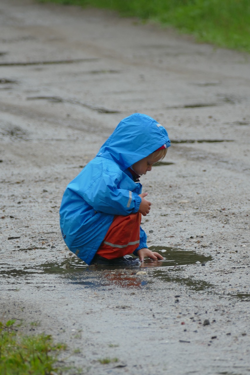 children playing rain puddle free photo