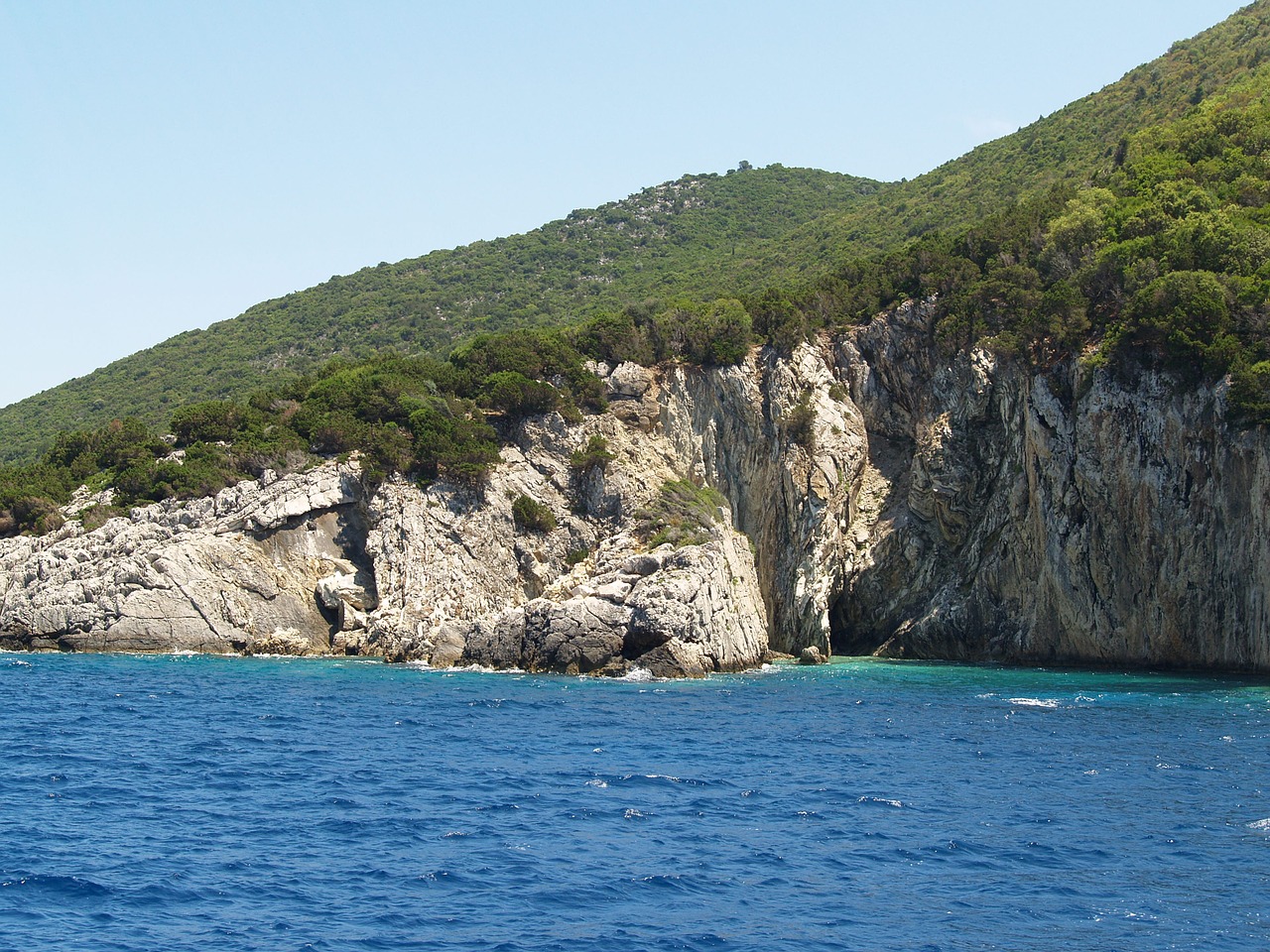 coast blue sea green rocks free photo