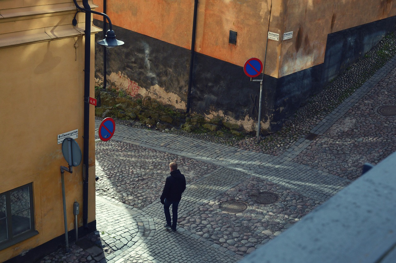 cobbled street solitary man free photo