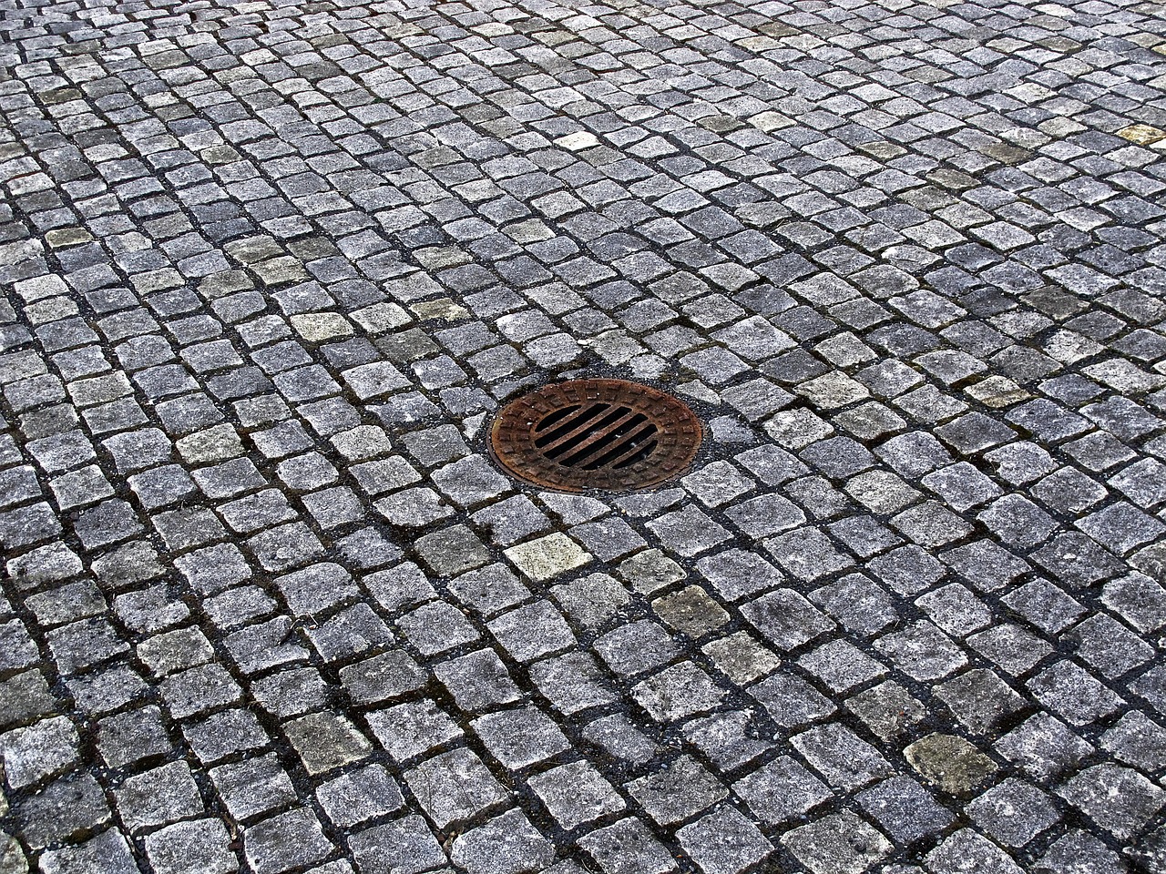 cobblestones gully manhole cover free photo