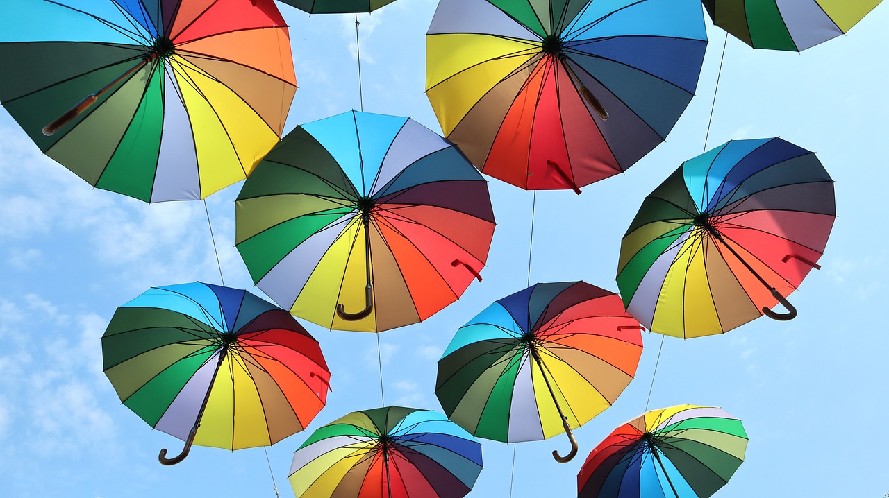 colored  sun umbrellas  rainbow color free photo
