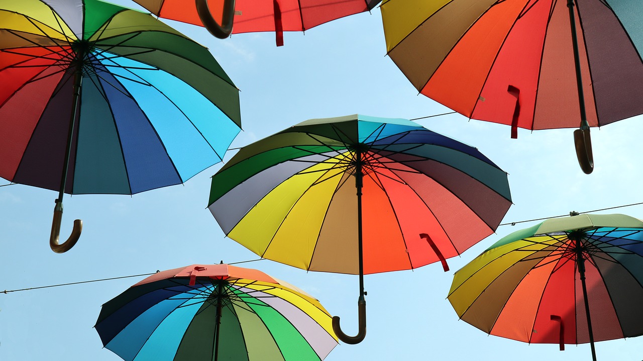 colored  sun umbrellas  rainbow color free photo