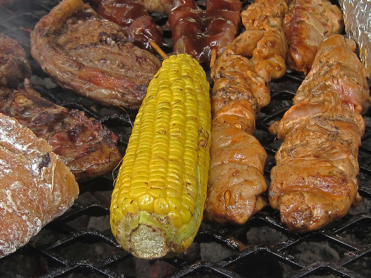 corn and meat on the fire corn yellow free photo