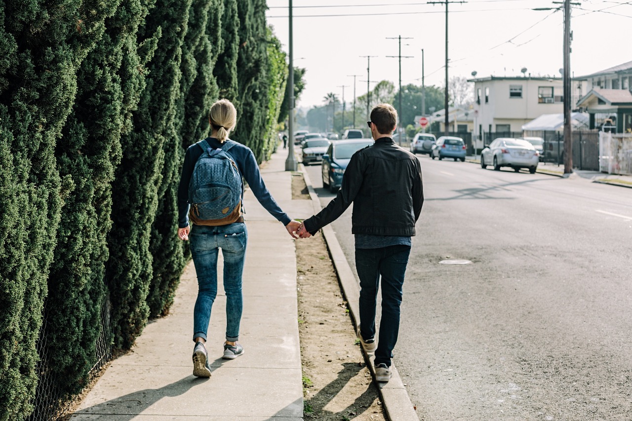 couple holding hands walking free photo