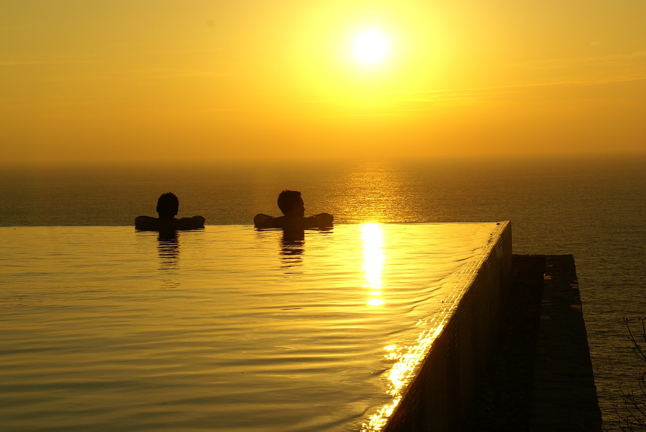 couple sunset pool free photo