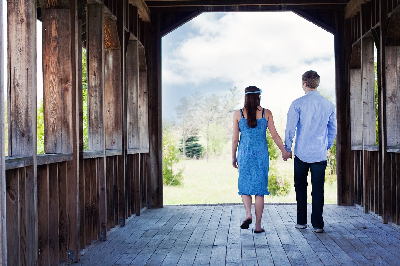 couple walking hand-in-hand free photo