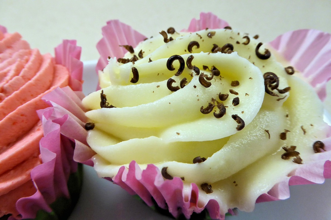 cupcake yellow frosting chocolate pieces free photo