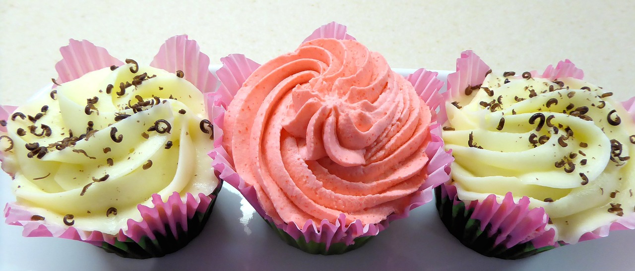 cupcakes yellow and peach frosting chocolate pieces free photo