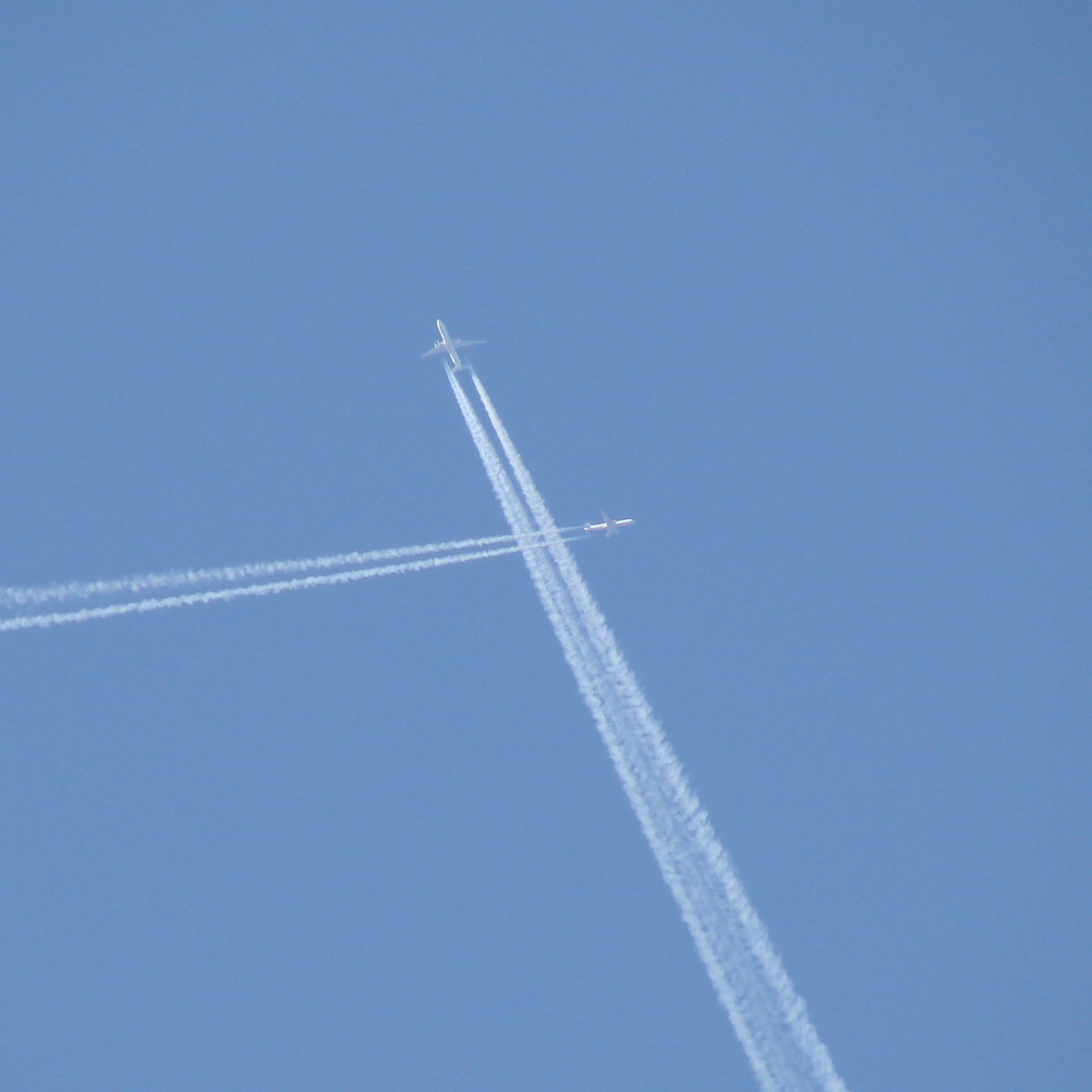 jets crossing paths sky free photo