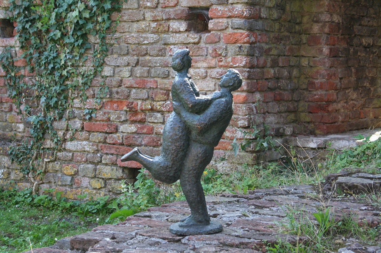 embrace meeting again bronze statue free photo