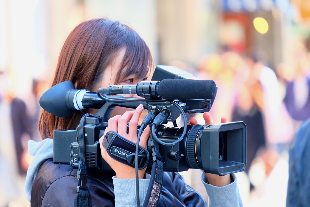 female  cameraman  shooting free photo