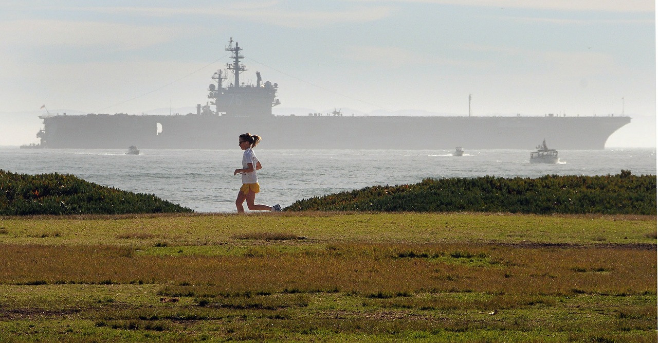 female jogger aircraft carrier seaside free photo