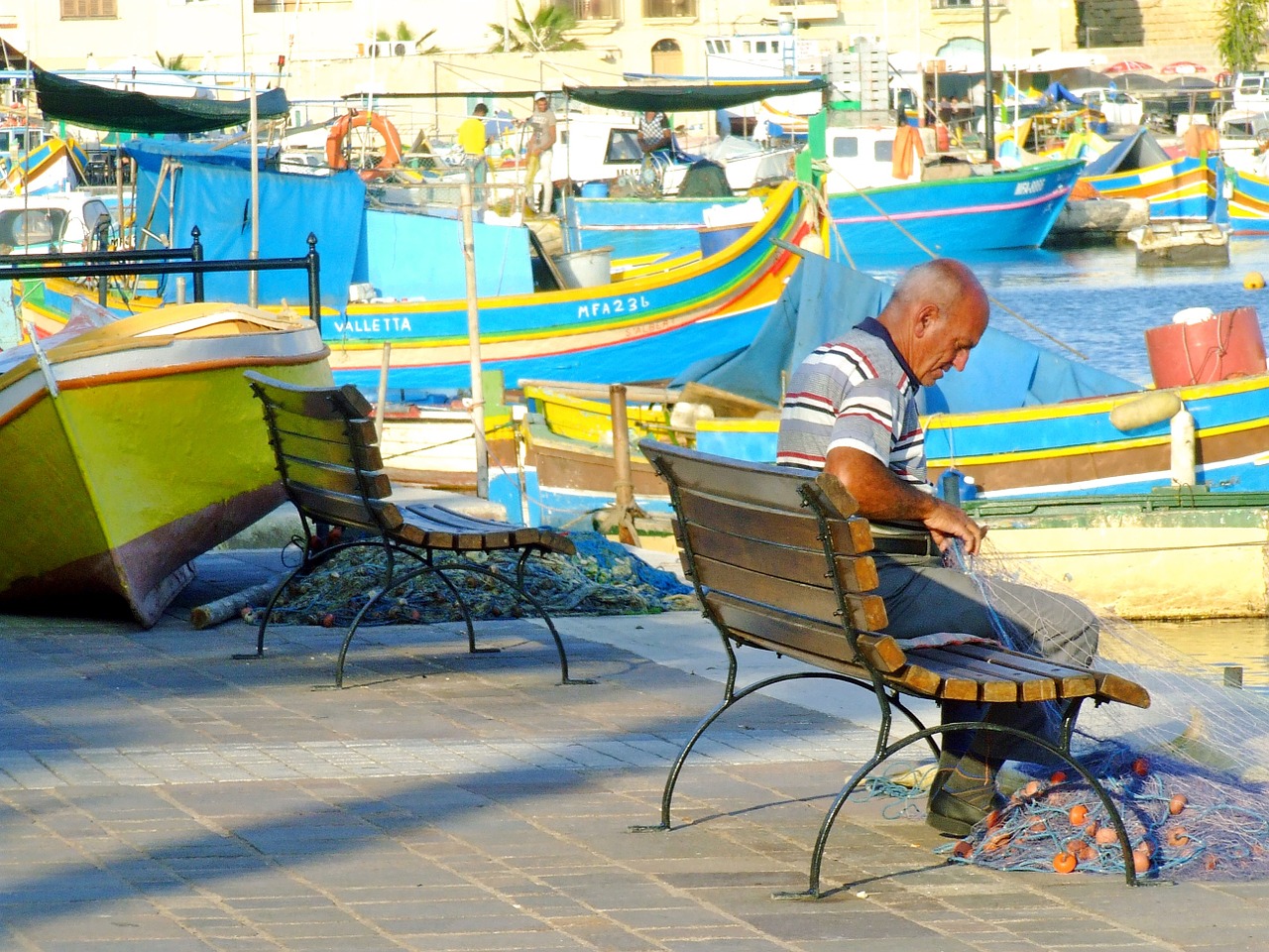 fisherman mending nets repairing fishing nets free photo