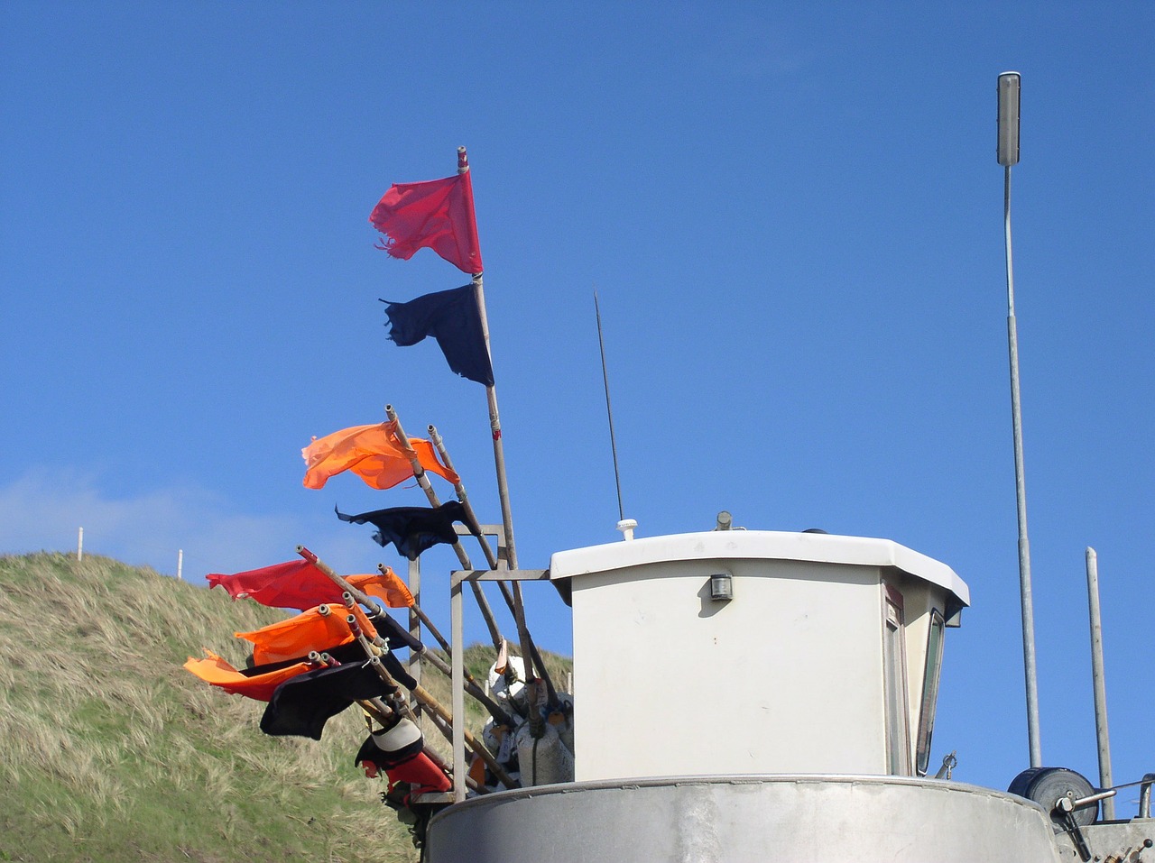 fishing boat flags sky free photo