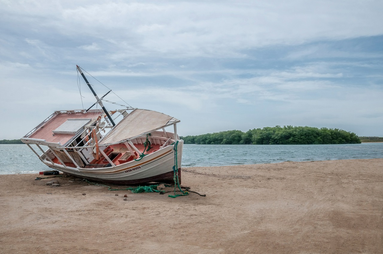 fishing boat aground beach free photo