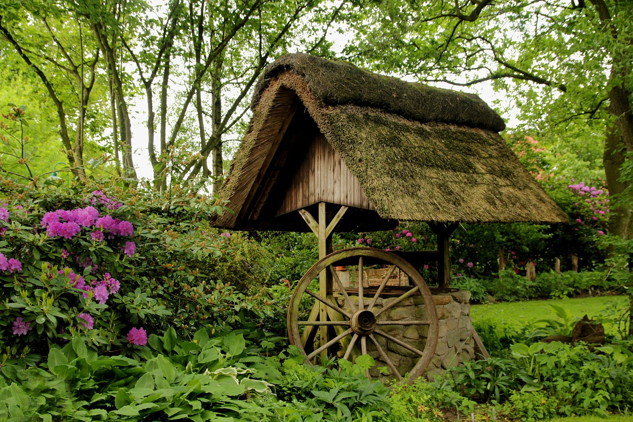 fountain thatched roof wagon wheel free photo