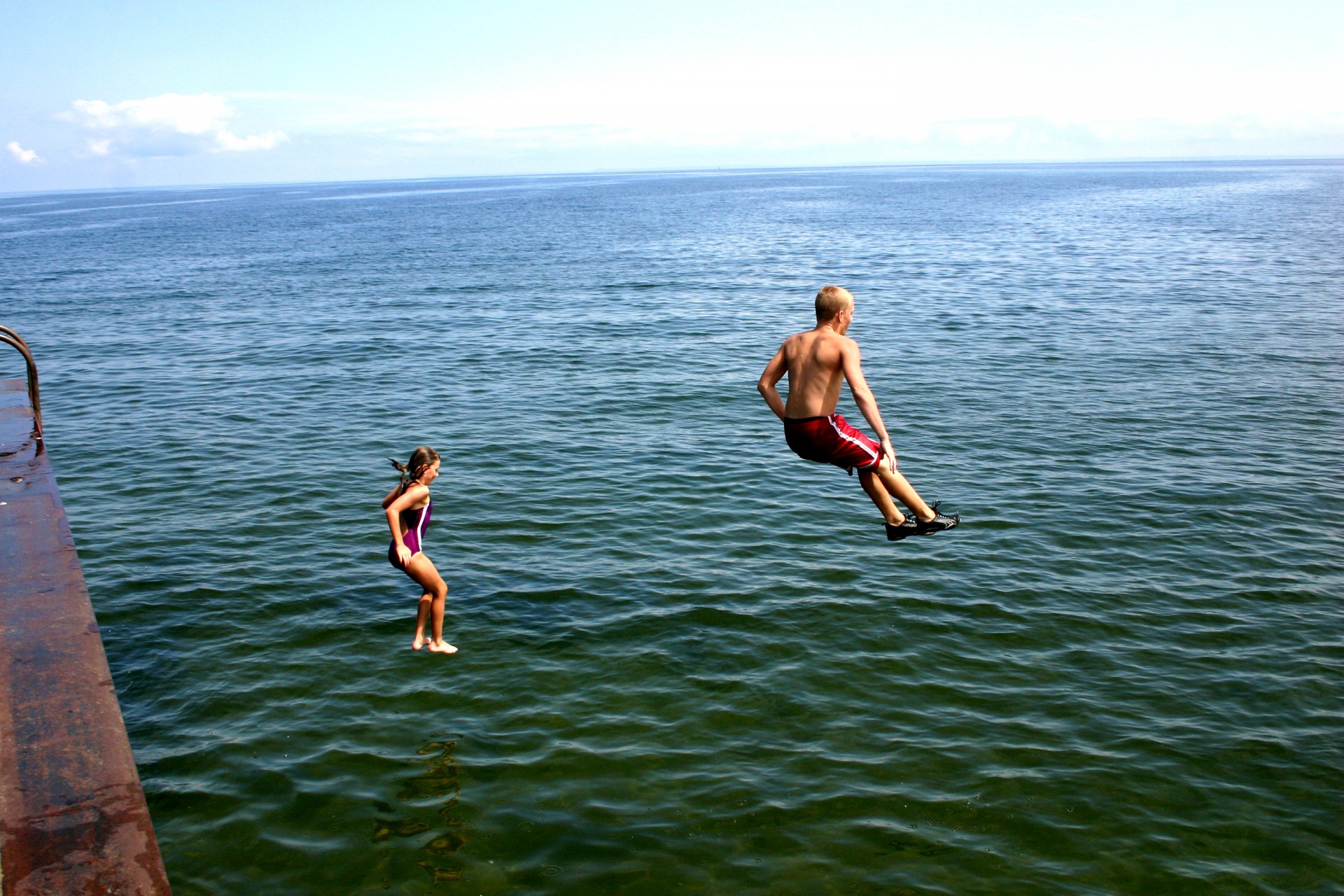 kids jumping water free photo