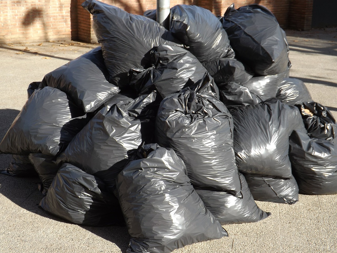 waste, black garbage bags plastic pile stack isolated on white