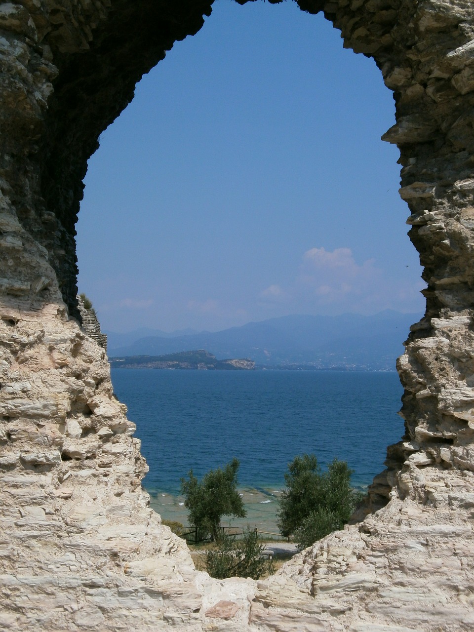 garda rock window lake view free photo