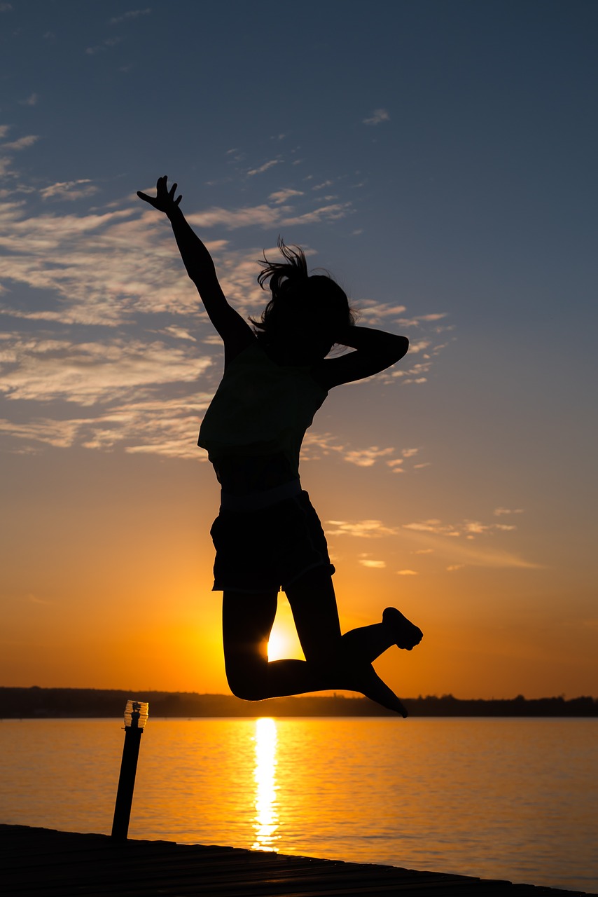 girl jumping back-light free photo